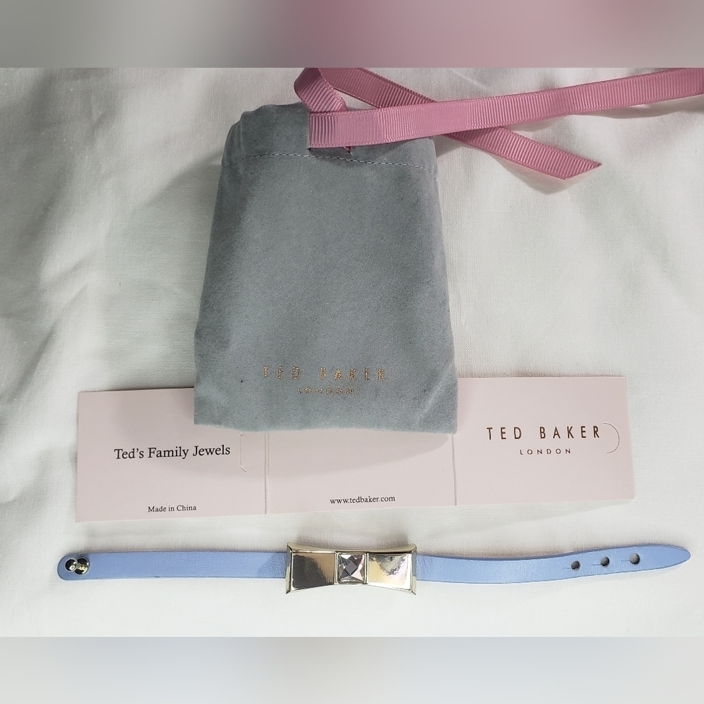 Periwinkle Ted Baker leather/metal bow bracelet. 7 1/2" long. Large gem on bow.